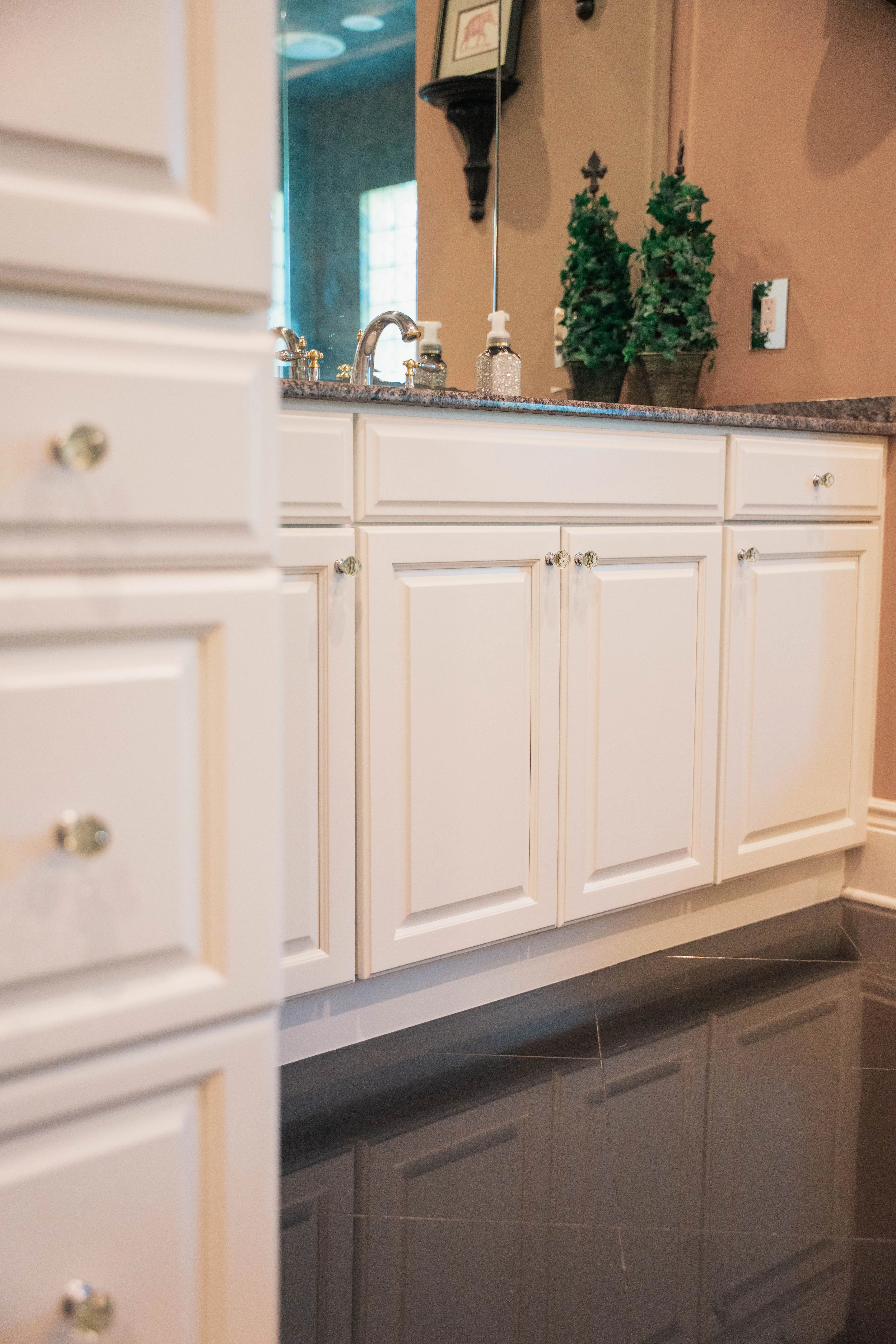 Bathroom remodel with painted white vanity cabinets and a granite countertop