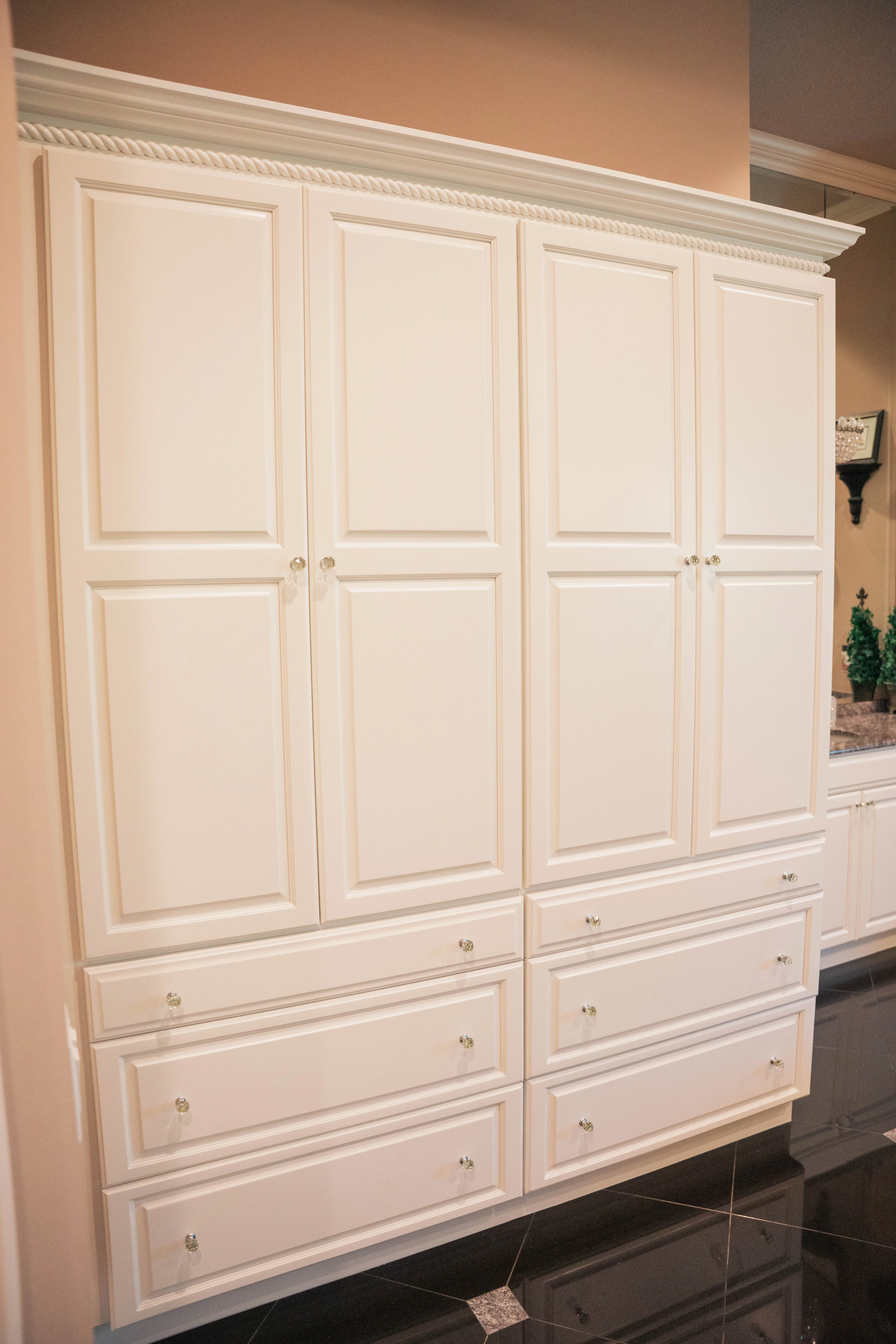 Bathroom remodel with tall white built-in cabinets and drawers